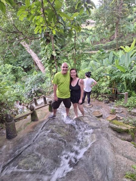 A couple standing mid-stream on the rock face - lifeonwheel.com