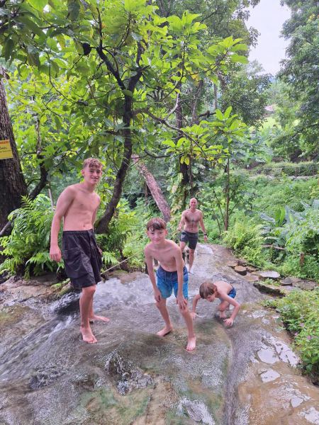 Boys playing in the shallow flowing water - lifeonwheel.com