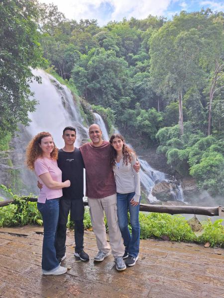 The full drop of Wachirathan Waterfall behind the family - lifeonwheel.com