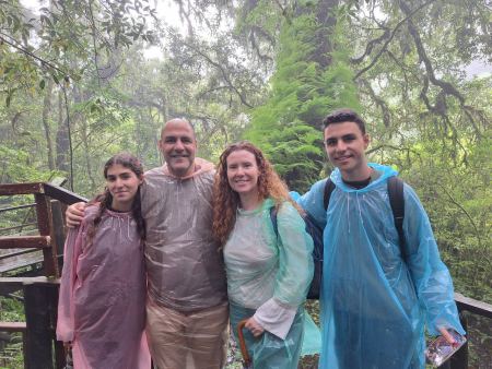 The family in rain ponchos on the misty boardwalk - lifeonwheel.com