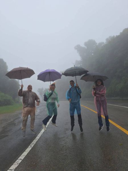 Jumping for joy in the fog with umbrellas up - lifeonwheel.com