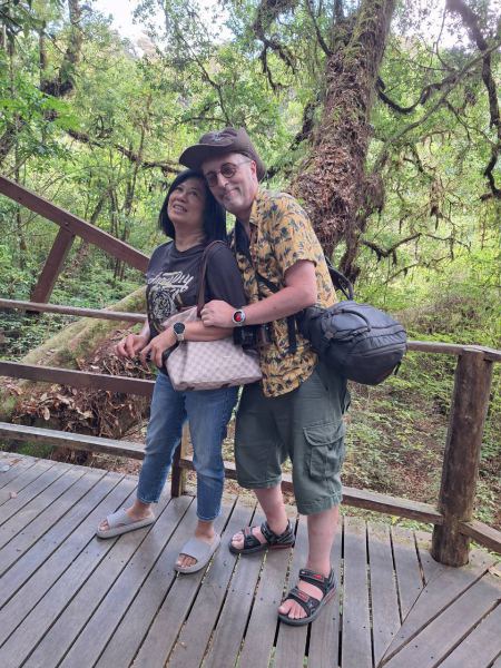 A couple pausing on the mossy forest platform - lifeonwheel.com