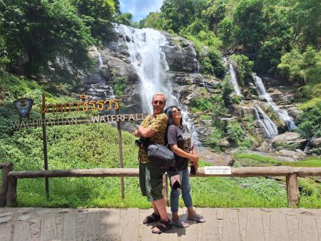 A couple close together before Wachirathan Waterfall - lifeonwheel.com
