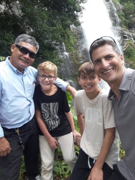 Our guide with three boys at the waterfall - lifeonwheel.com