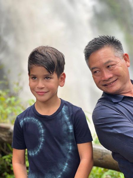 A boy and our guide with the misty falls behind - lifeonwheel.com