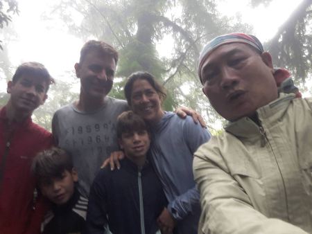 A large family group in the fog on the summit trail - lifeonwheel.com