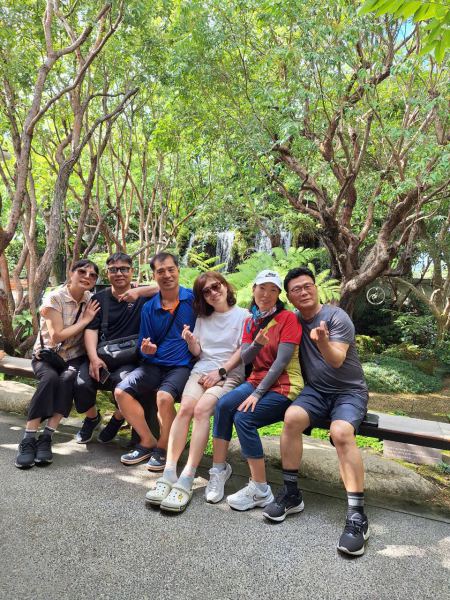 The group resting by the waterfall garden feature - lifeonwheel.com