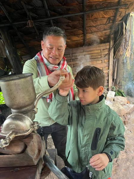 Our guide showing a young guest the hand coffee grinder - lifeonwheel.com