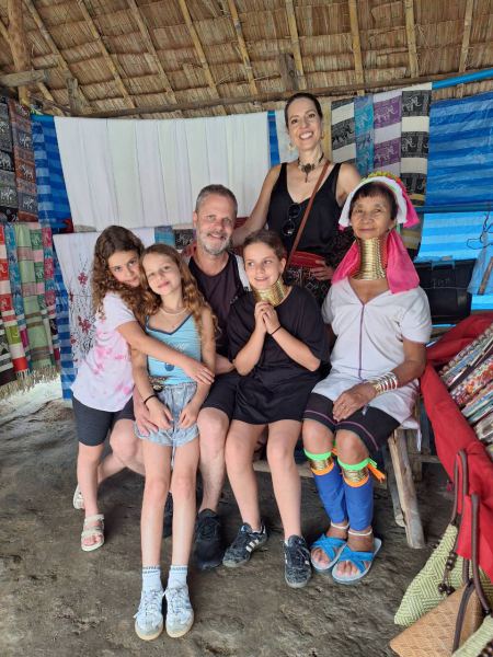 A family photo with a Karen elder in her home - lifeonwheel.com