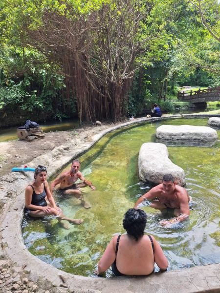 Guests relaxing along the natural hot spring channel - lifeonwheel.com