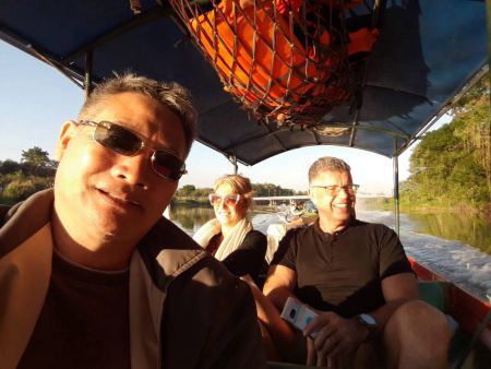 Heading up the Mekong by long-tail boat in the late sun - lifeonwheel.com