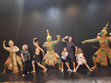 A family posing with the khon dance figures - lifeonwheel.com
