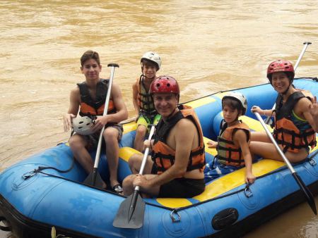 A family rafting together through calmer water - lifeonwheel.com