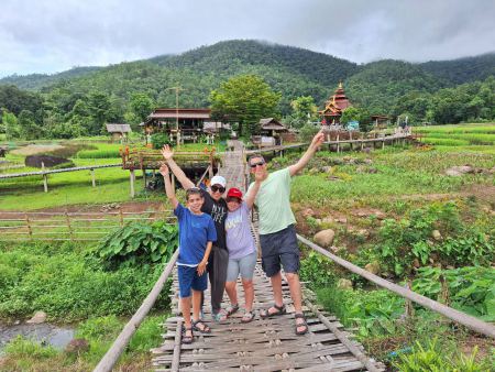 Arms up on the bamboo bridge above the rice paddy - lifeonwheel.com