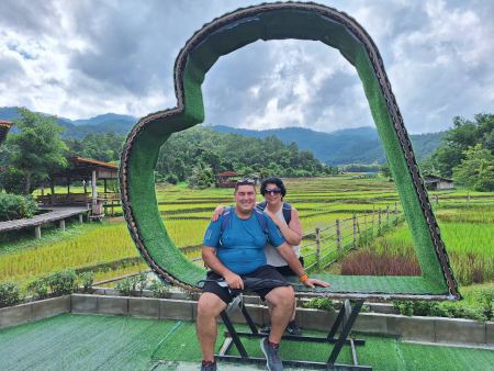 A couple in the giant heart frame above the paddies - lifeonwheel.com