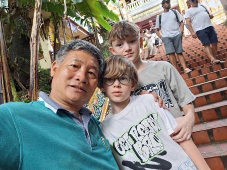 Our guide with young guests on the temple steps - lifeonwheel.com