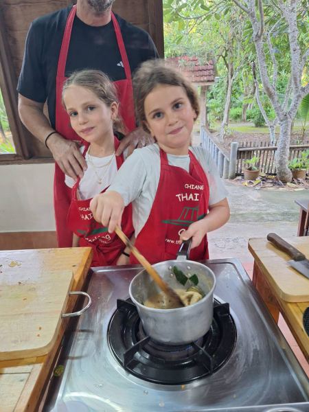Young cooks stirring their own pot of soup - lifeonwheel.com