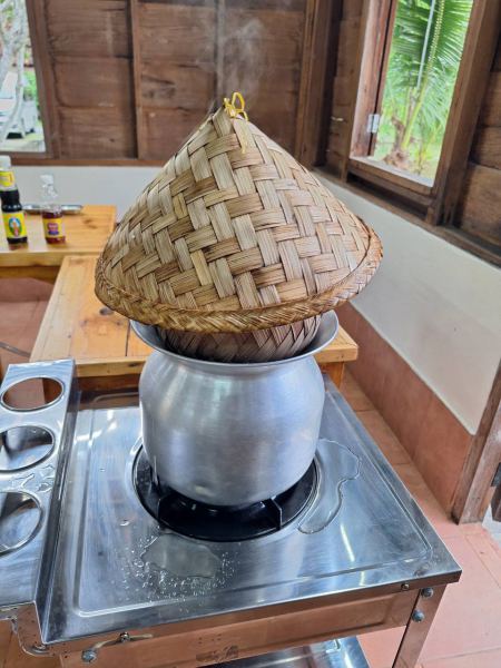 Sticky rice steaming in a bamboo basket - lifeonwheel.com