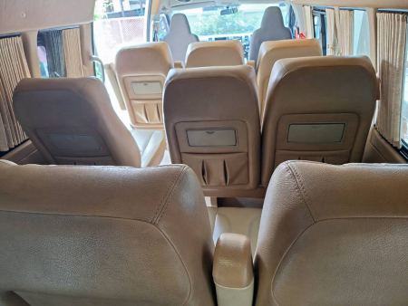Rows of leather seats inside the private van - lifeonwheel.com
