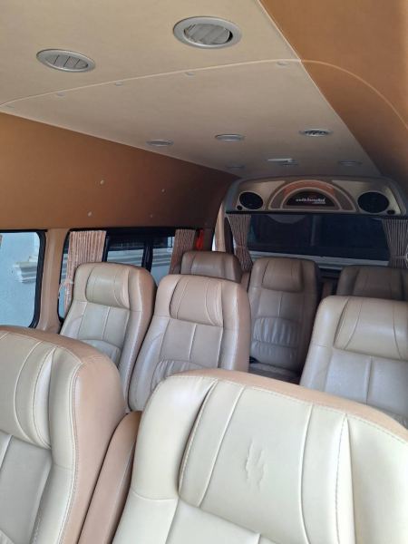 Two rows of leather captain's chairs inside the van - lifeonwheel.com