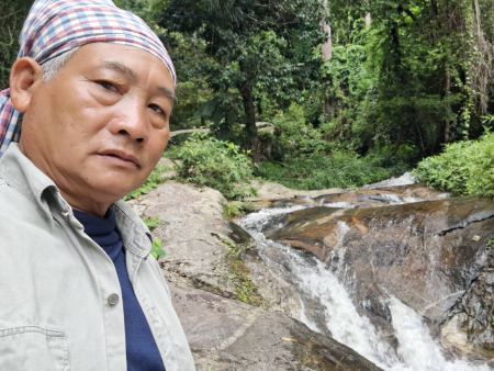 Our guide beside a small cascading waterfall - lifeonwheel.com