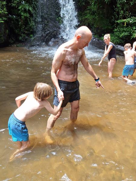Father and son wading through the muddy pool - lifeonwheel.com