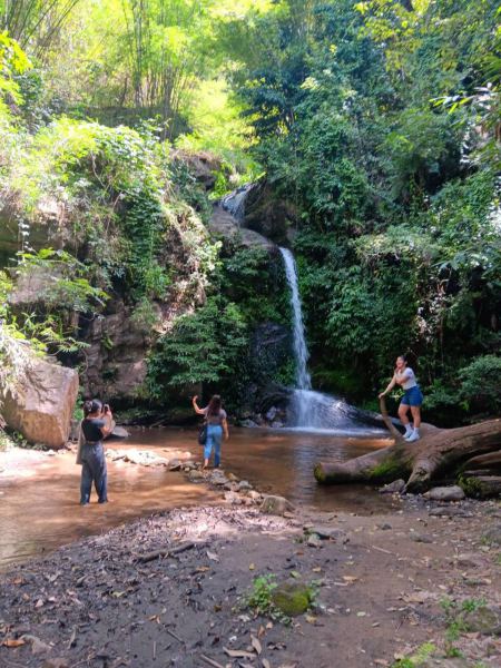 Guests photographing each other by the cascading falls - lifeonwheel.com