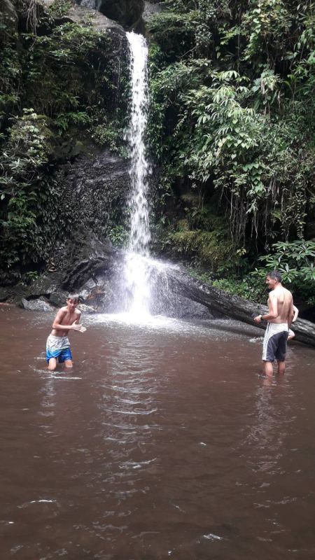 Two guests wading at the base of the falls - lifeonwheel.com
