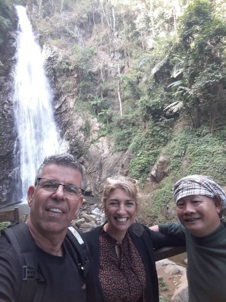 A group selfie with the tall waterfall behind - lifeonwheel.com