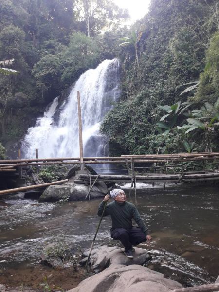 Our guide resting by the bamboo bridge below the falls - lifeonwheel.com