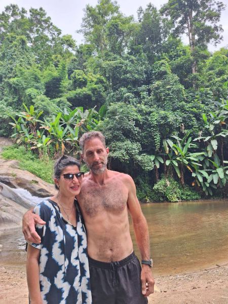A couple by the calm jungle river - lifeonwheel.com
